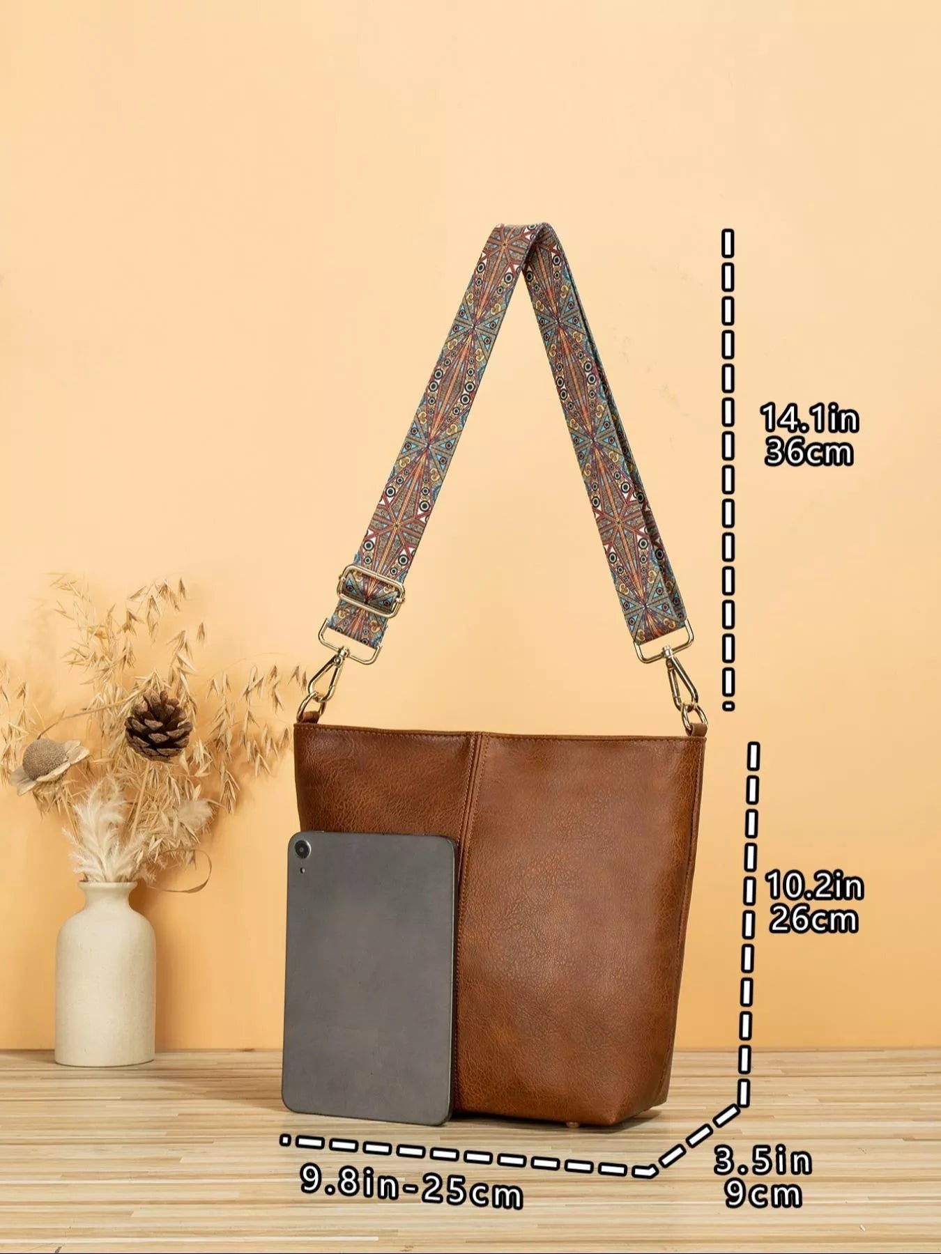Medium PU leather tote bag with wide patterned mosaic strap and structured silhouette.
