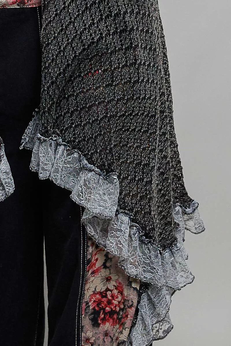 Sleeveless crochet vest with openwork texture, lace details, cascading ruffle hem, and lightweight boho layering style.
