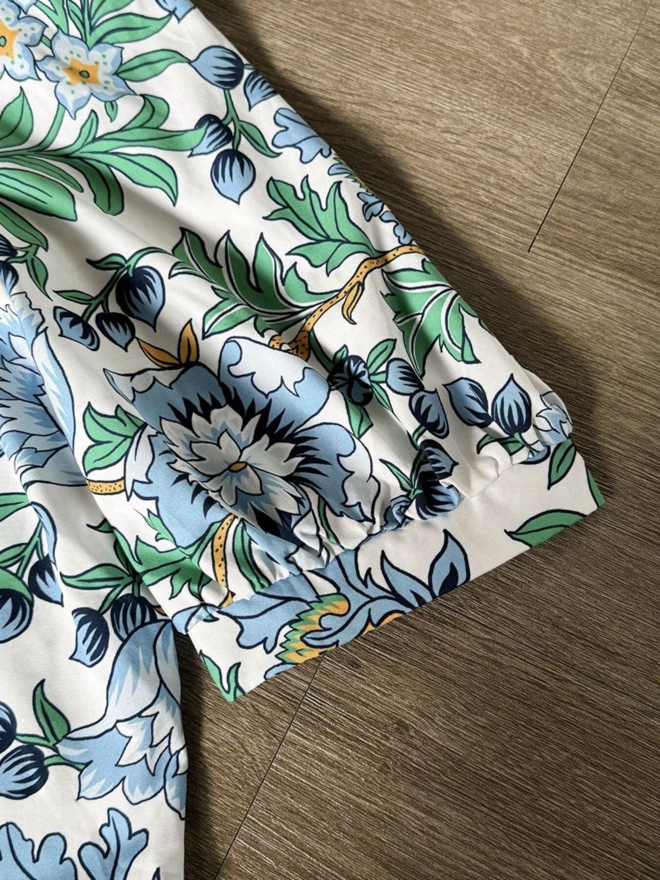 White blouse with blue green floral botanical print and gathered neckline