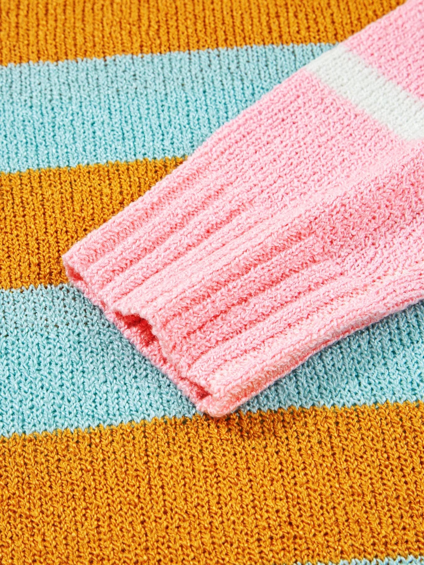 Candy Stripe Sweater β playful color block knit with pink, teal, white, and yellow stripes.