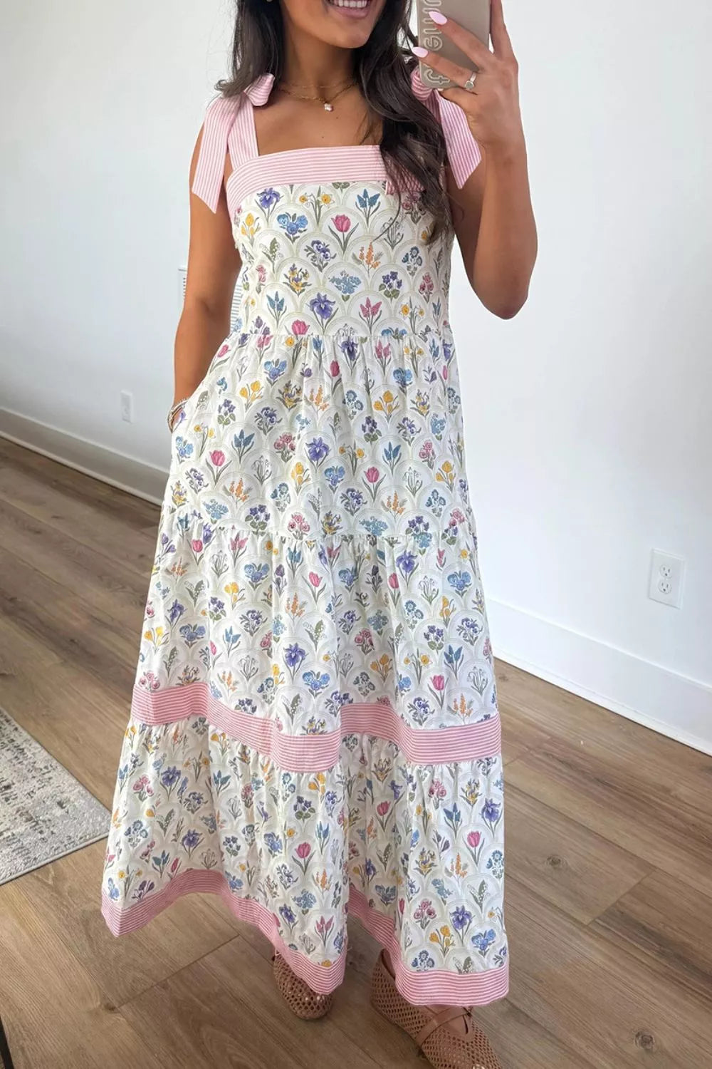 Floral tiered midi dress with pink tie-shoulder detail, contrast trim, flowy skirt, and breezy garden-inspired style.