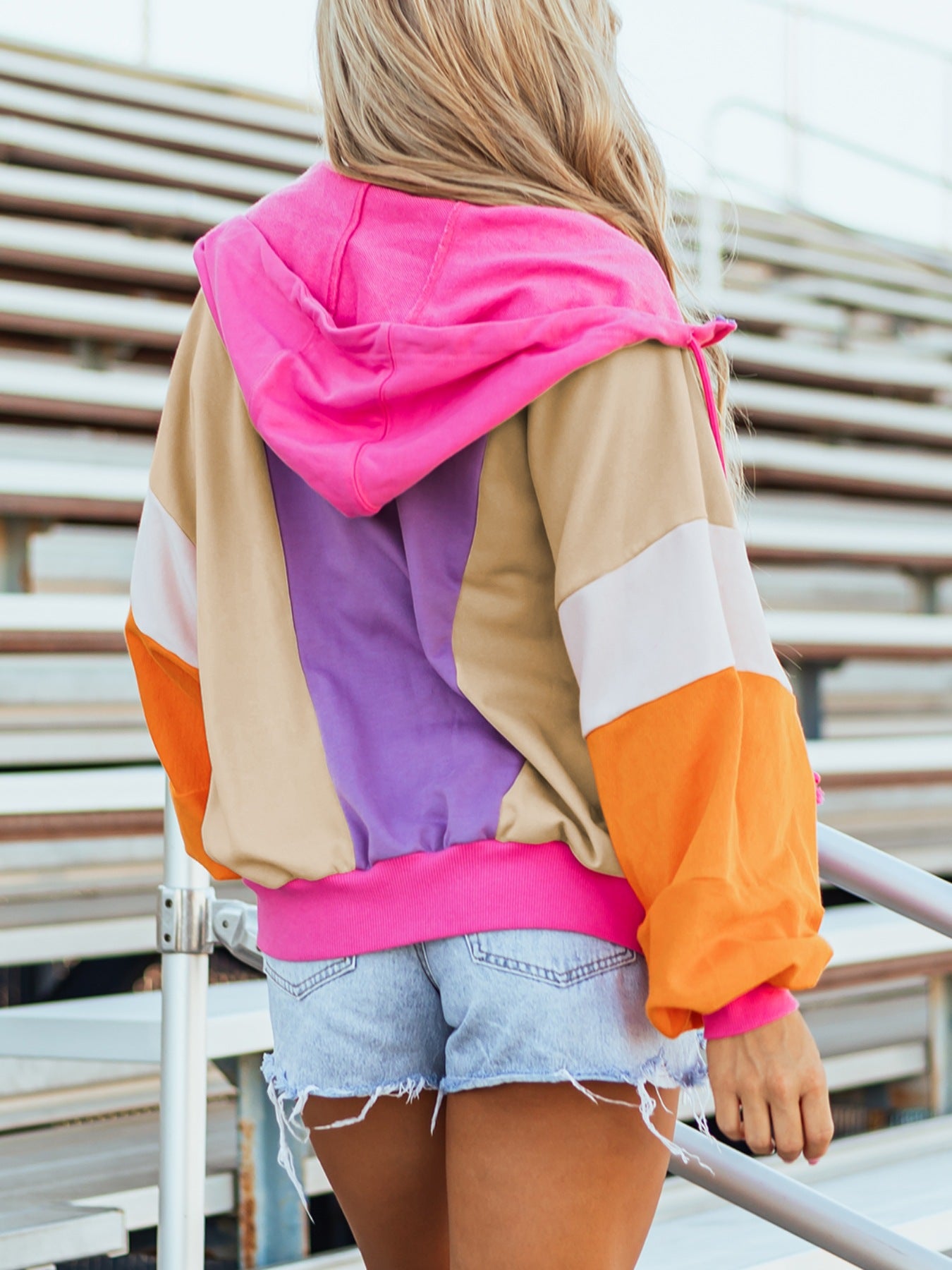 Retro colorblock zip hoodie in pink, orange, purple, and tan with drawstring hood and pockets
