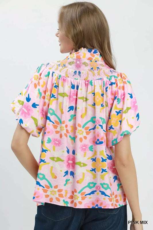 Pink mix folk art floral blouse with smocked neckline detail, split collar, puff sleeves, and relaxed boxy fit.