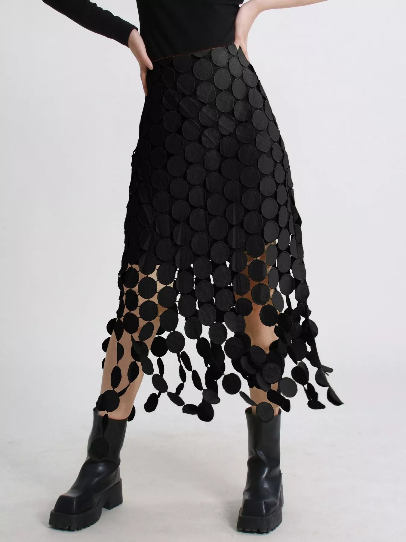 Black fringe midi skirt with cutout circles and flowing fringe detail