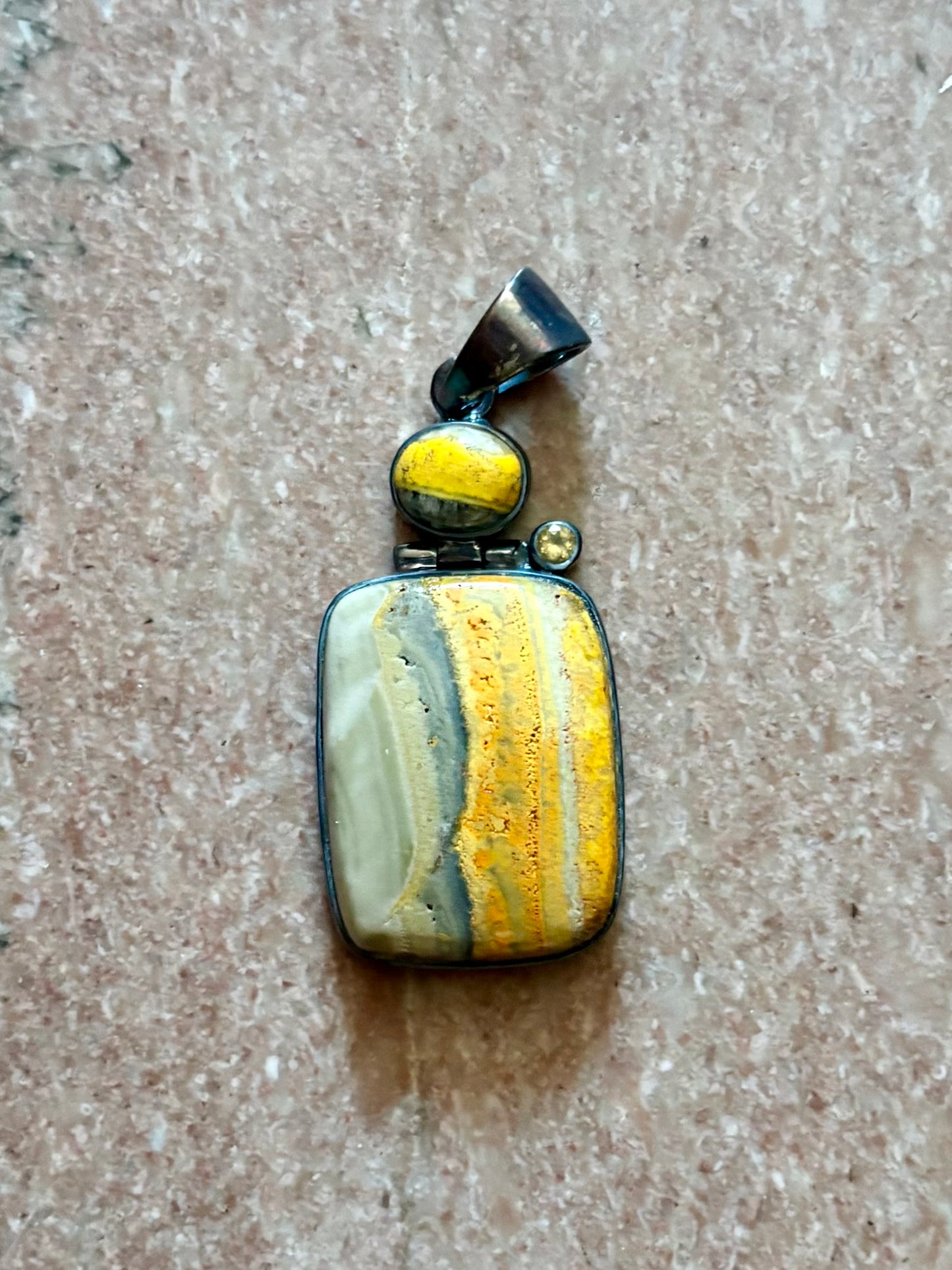 Sterling silver bumble bee jasper pendant featuring natural golden yellow and gray banded stone.