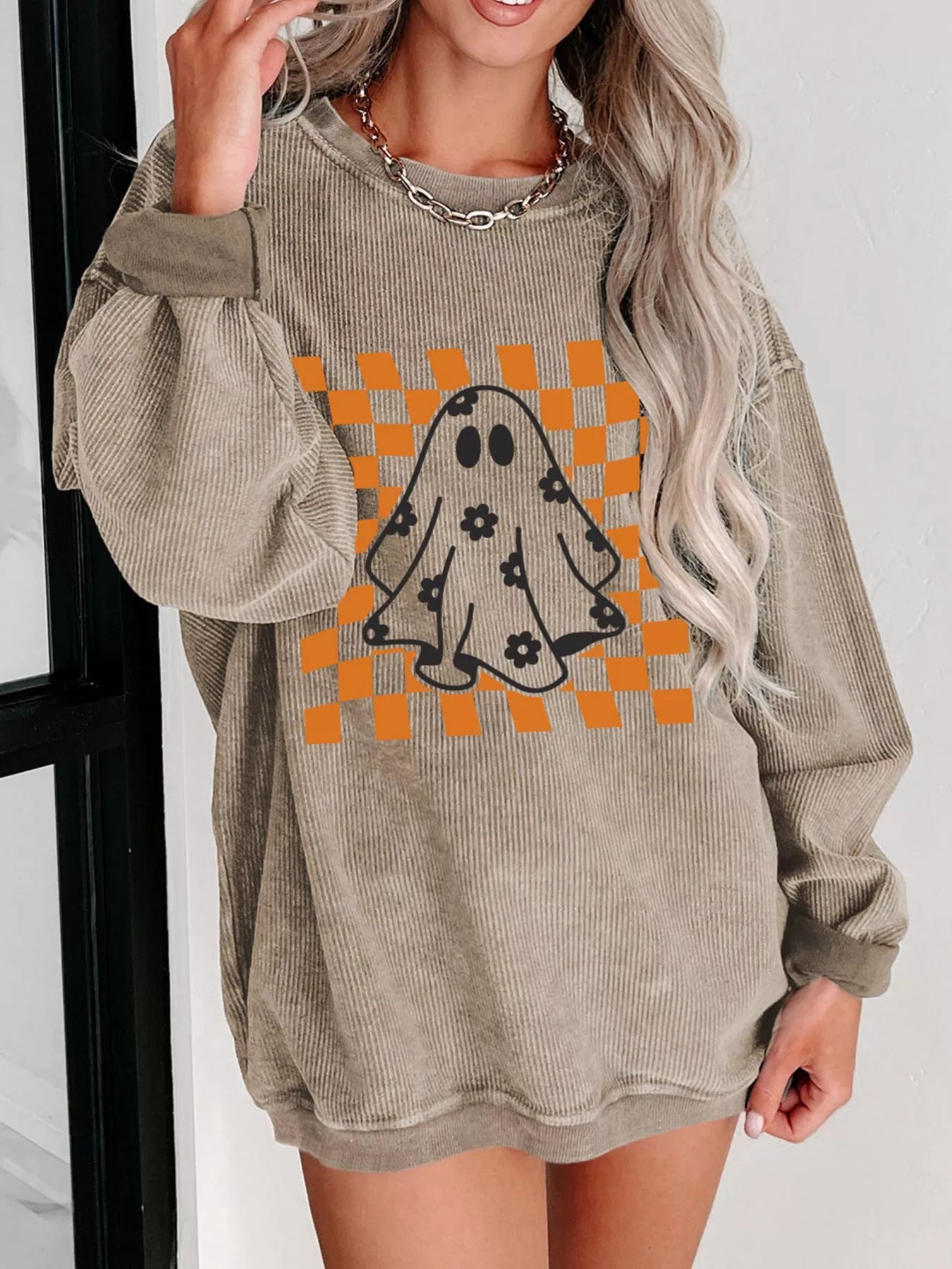 Oversized corded sweatshirt with ghost graphic on retro orange checkerboard with floral accents – Groovy Ghost style from A Whimsical Affair.