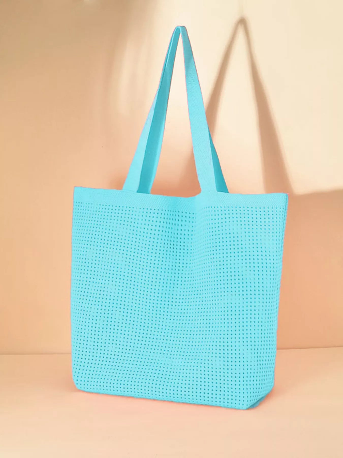 Large mesh shoulder tote bag made from lightweight polyester, perfect for beach days, markets, travel, and everyday errands.