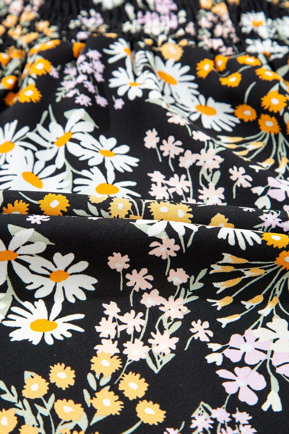 Black floral peplum blouse with smocked waist and short sleeves
