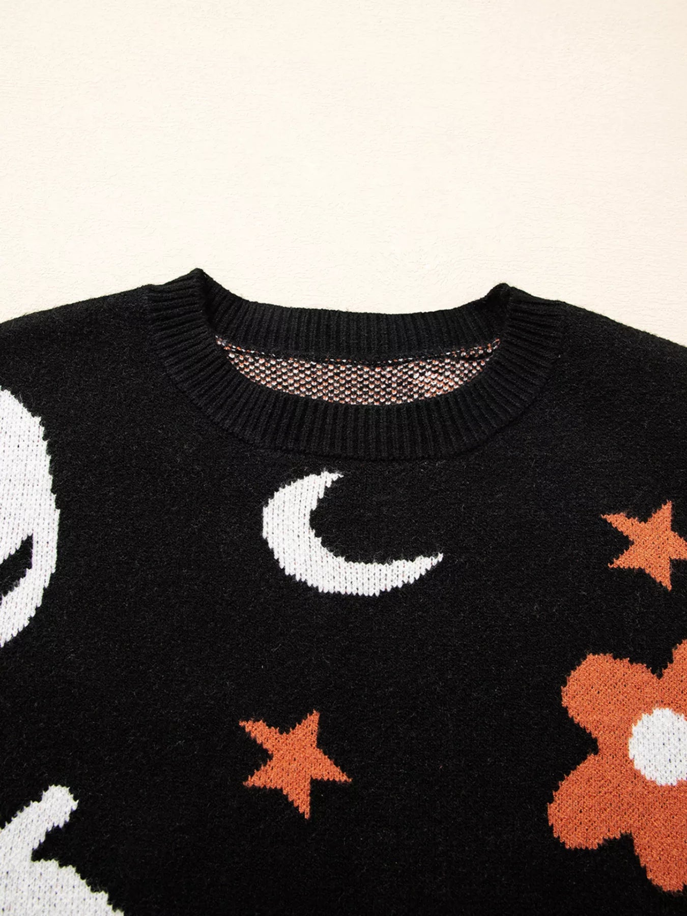 Black Halloween sweater with jack-o’-lanterns, moons, stars, and flowers – Midnight Magic style from A Whimsical Affair.