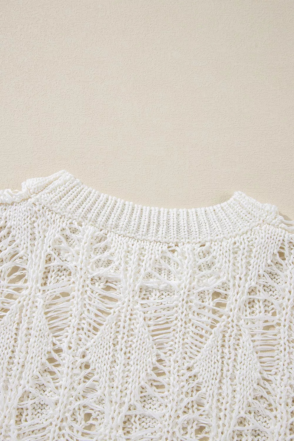Ivory open knit boho sweater with long sleeves and intricate cutout pattern