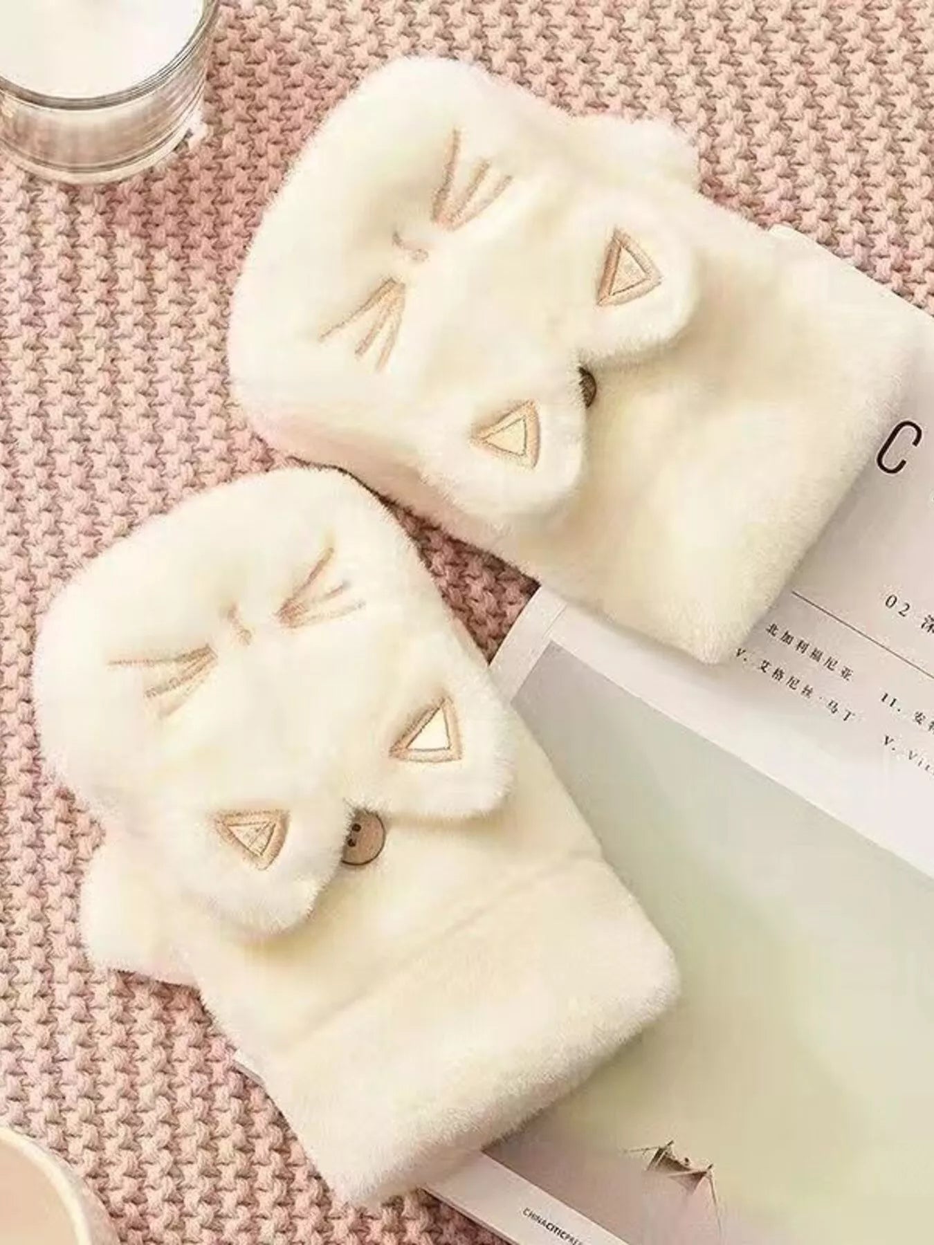 Cream plush fingerless gloves with embroidered cat paw face details