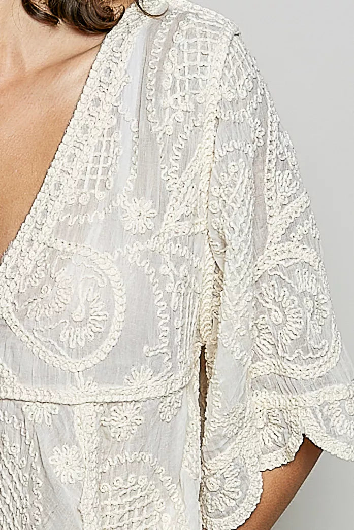 Bohemian crochet V-neck top with scalloped hem and short sleeves in a vintage wash