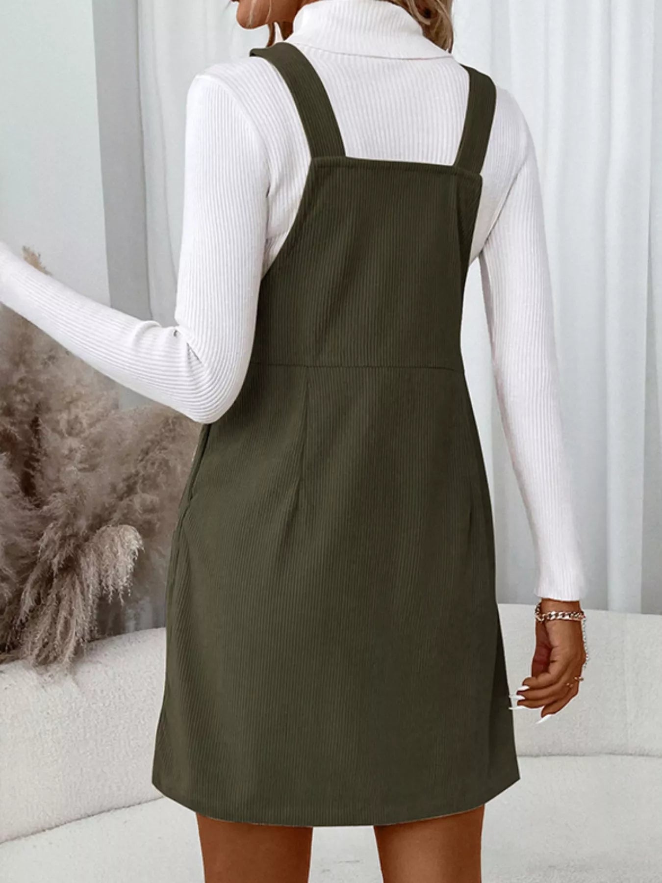 Olive green Pinafore Dreams corduroy overall dress with front pocket and button sides