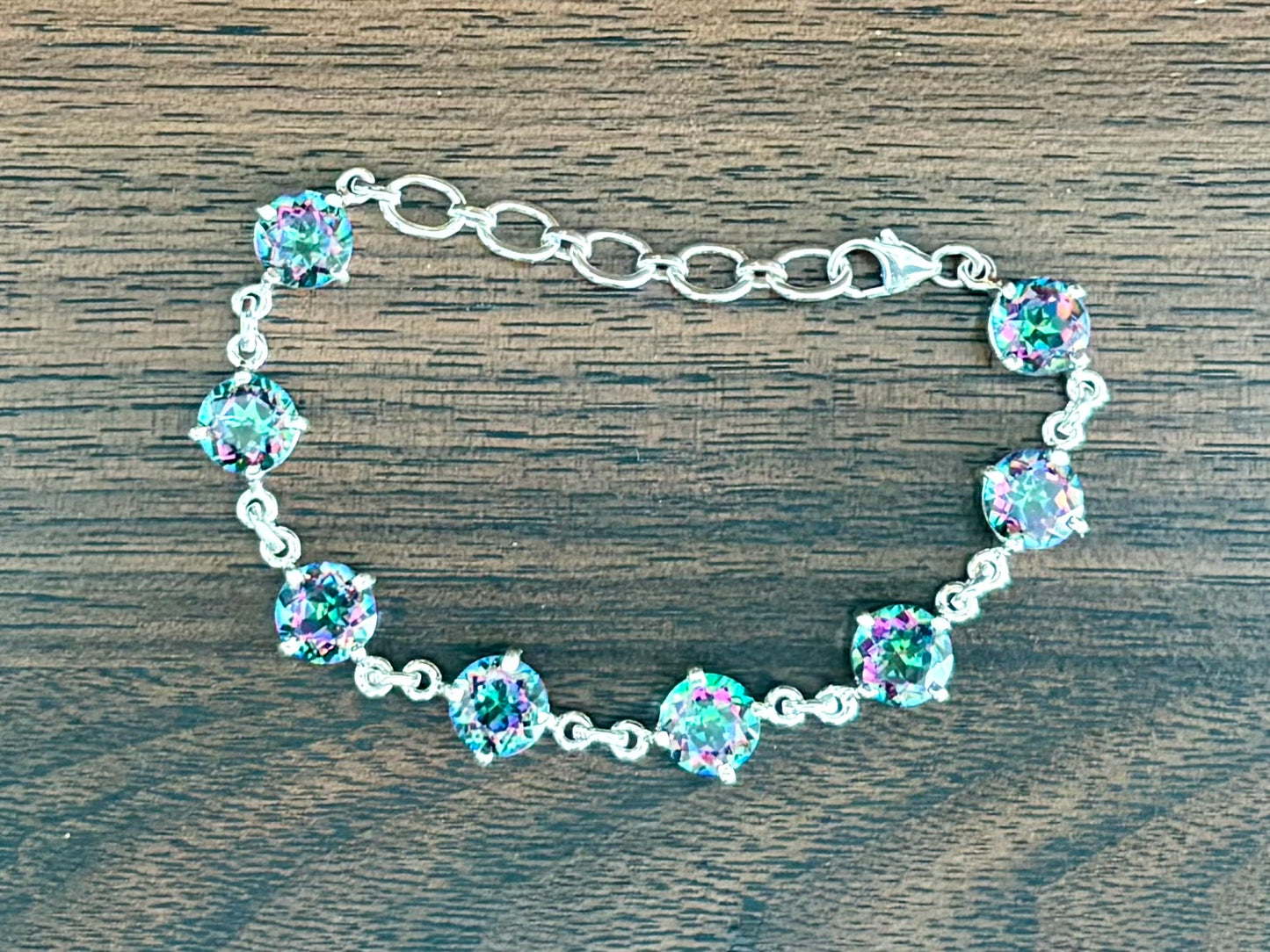 Sterling silver mystic quartz bracelet featuring iridescent round stones that shift colors in the light.