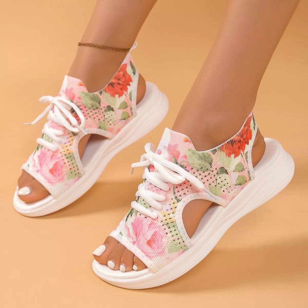 Colorful tie-dye mesh flat sandals with white laces, cutout sides, open toe design, and white rubber sole.