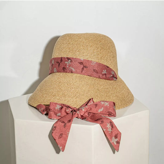 Woven straw sun hat with floral ribbon tie straps