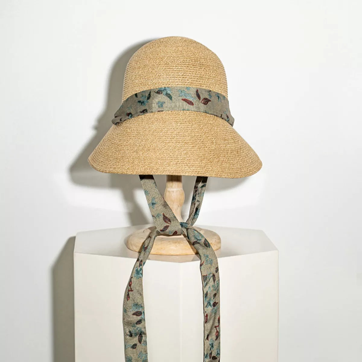 Woven straw sun hat with floral ribbon tie straps