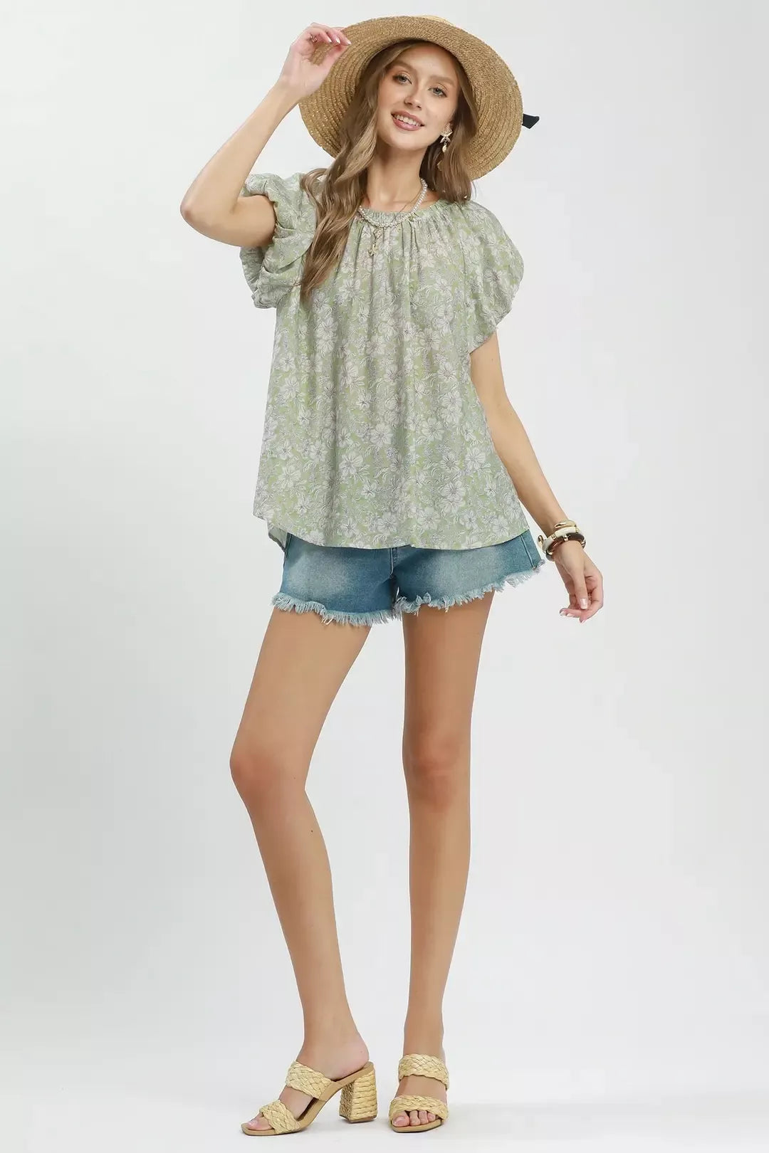Floral puff sleeve blouse with a gathered round neckline, relaxed flowy fit, and lightweight rayon-blend fabric styled with denim shorts.