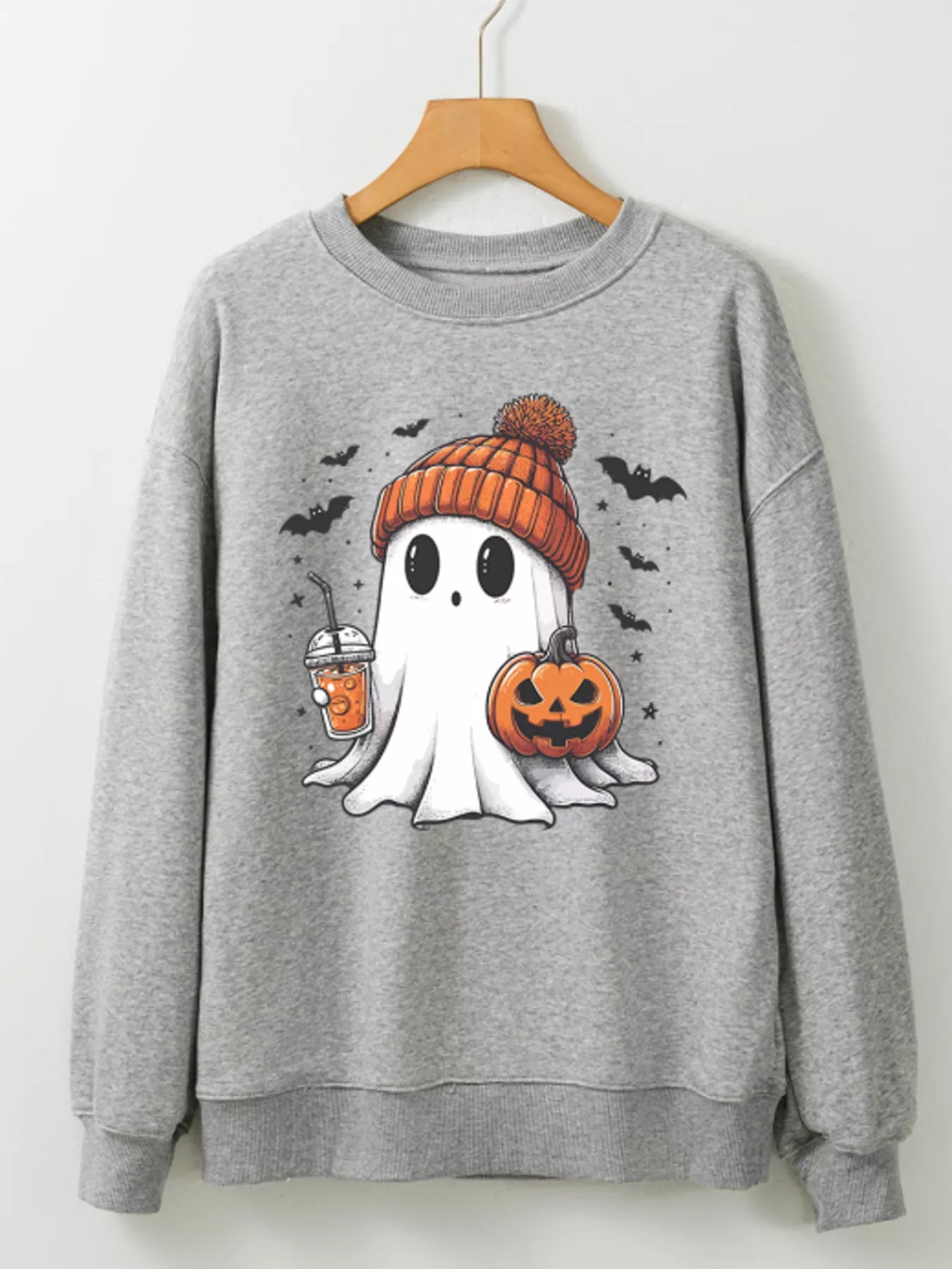Gray sweatshirt with ghost in orange beanie holding coffee and jack-o’-lantern, surrounded by bats – Sippin’ Spooky style from A Whimsical Affair.