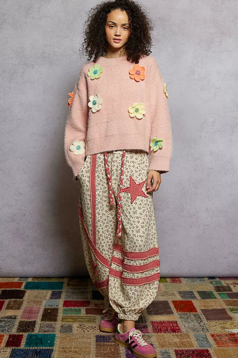 Model wearing the Sugar Blossom Mohair Sweater — a soft pink fuzzy knit with colorful 3D floral appliqués, paired with floral skirt.