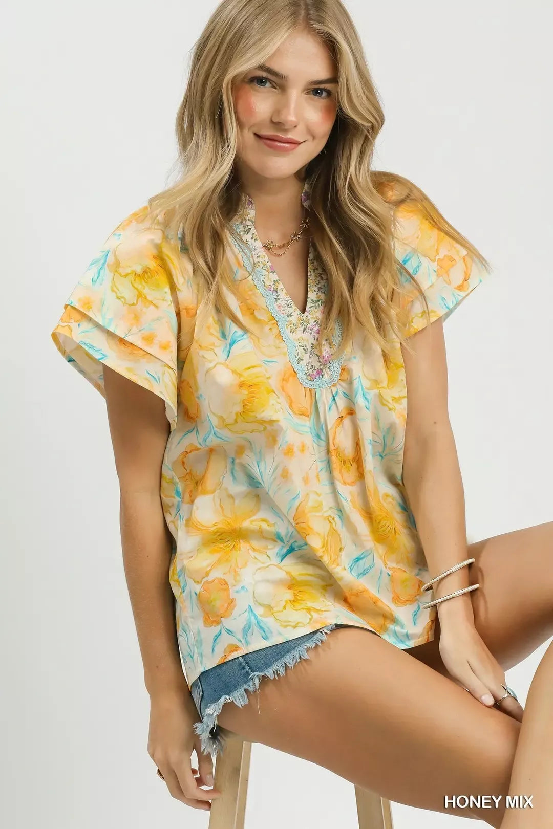 pastel floral ruffle sleeve blouse with yellow and blue watercolor flowers in a romantic boho style