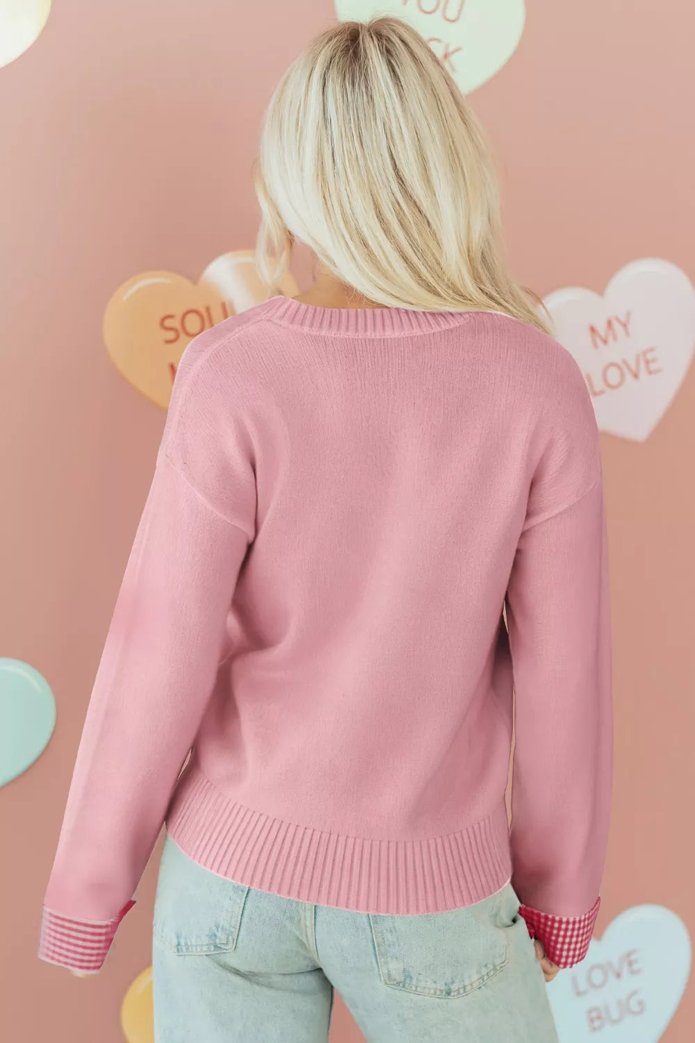 Blush pink knit sweater with embroidered gingham heart and gingham cuff details