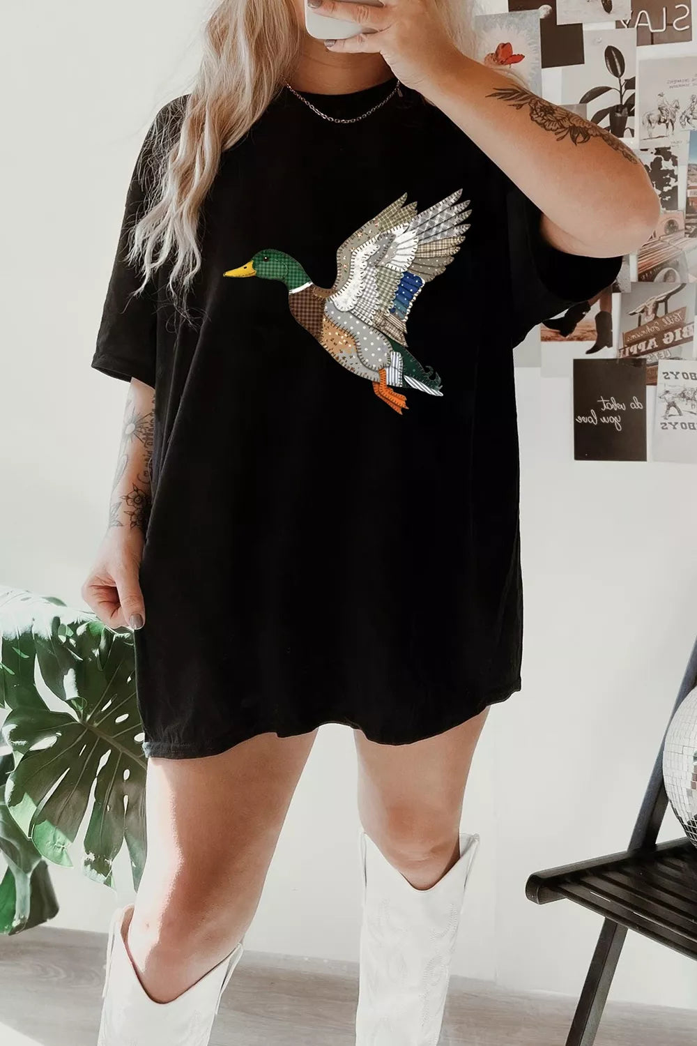 Black short sleeve graphic tee with a patchwork-style flying mallard duck design, relaxed fit, and slightly stretchy cotton-blend fabric.