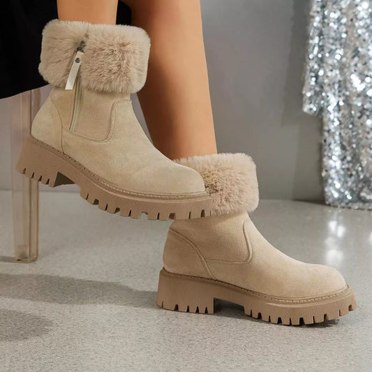 Women’s suede winter boots with plush fur cuff detail and mid-height rubber sole.