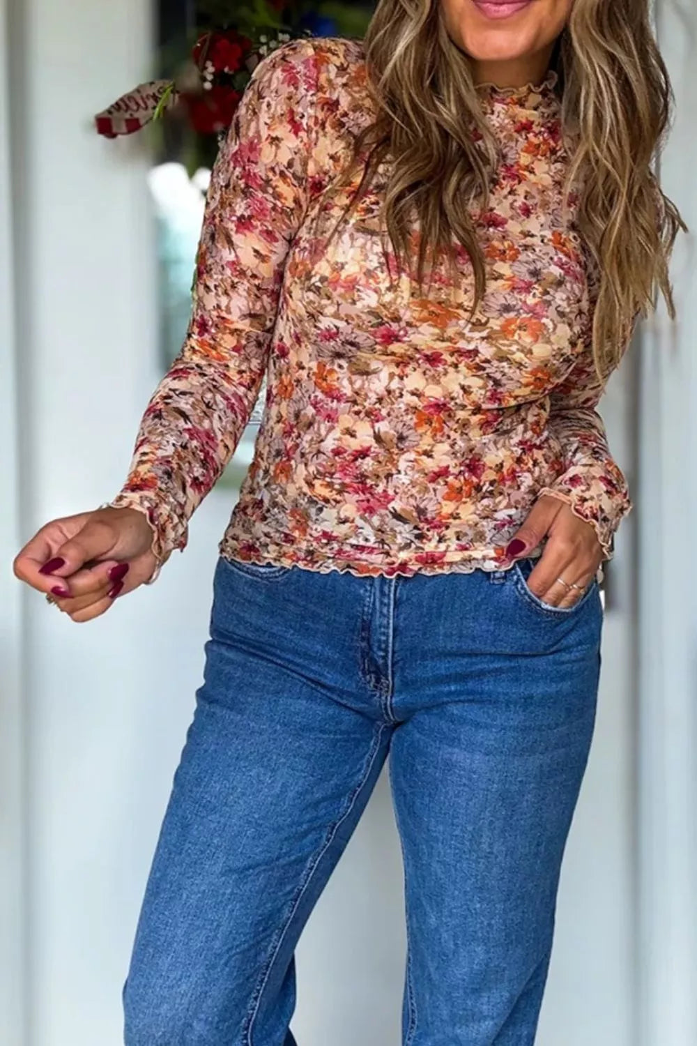 Sheer long sleeve floral top with warm autumn colors and ruffled edges.