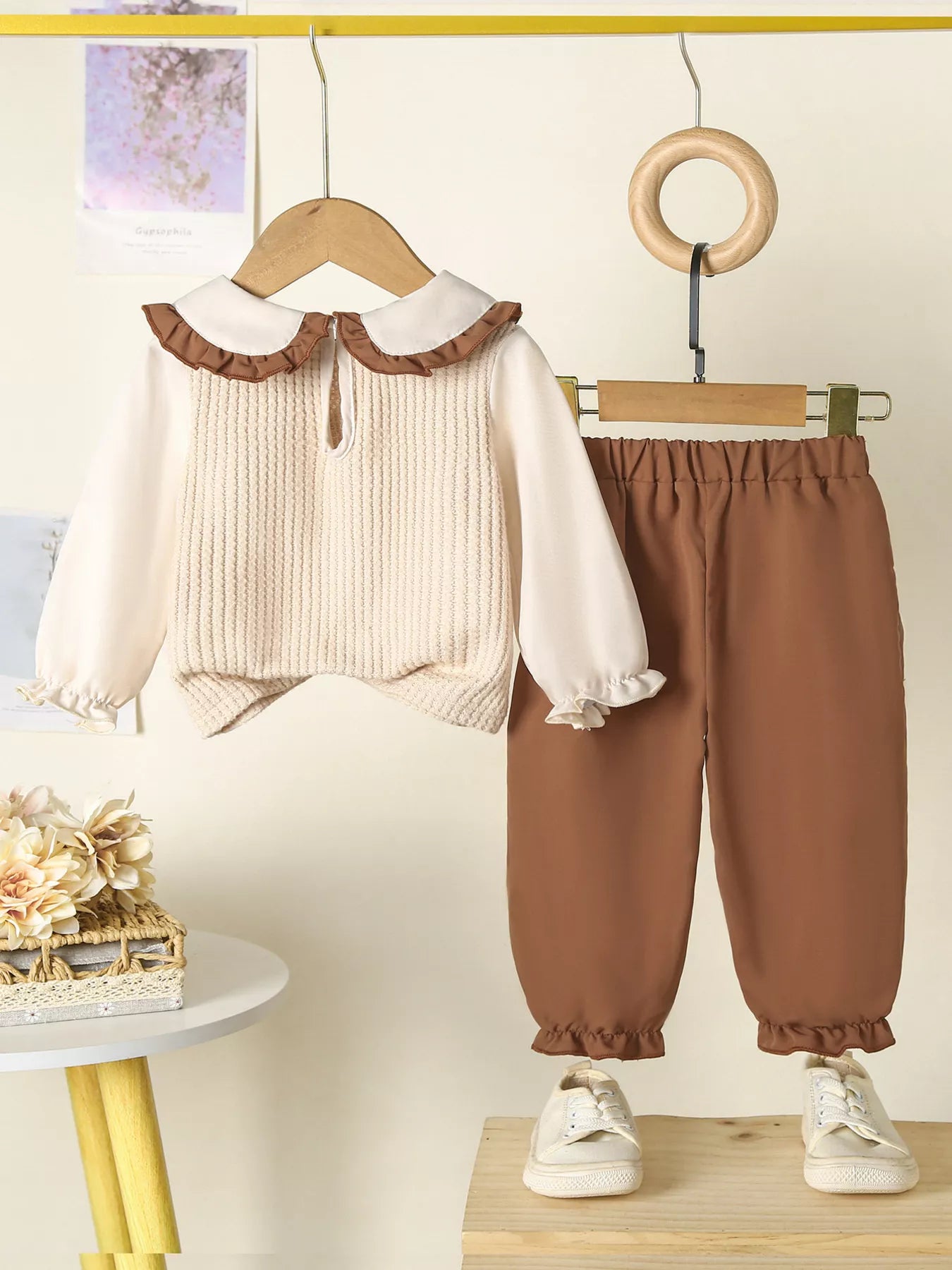 Beige and brown toddler floral knit top and pants set hanging on display