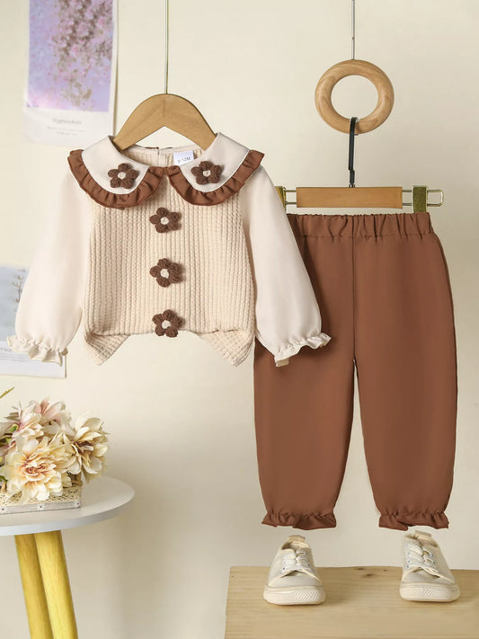 Beige and brown toddler floral knit top and pants set hanging on display