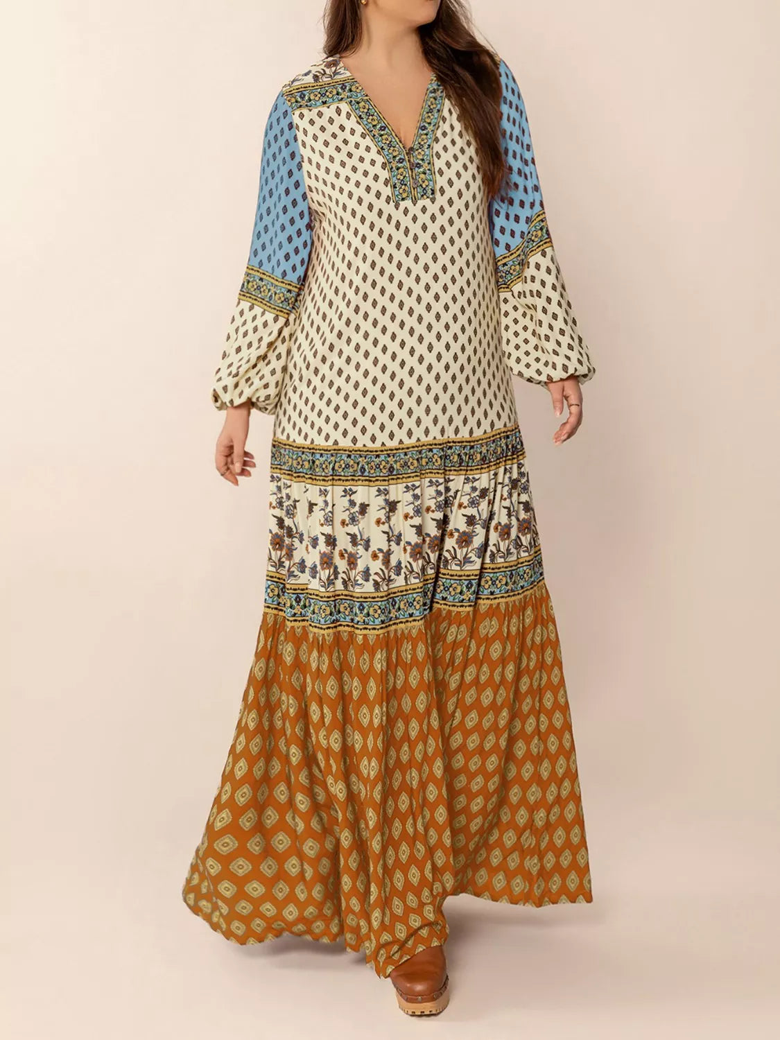 Woman wearing a bohemian patchwork maxi dress in ivory, blue, and rust tones – flowy tiered boho style from A Whimsical Affair.