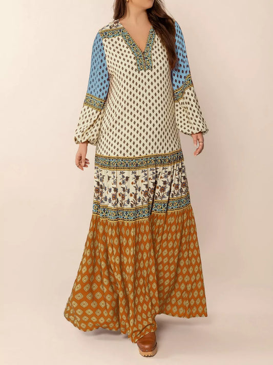 Woman wearing a bohemian patchwork maxi dress in ivory, blue, and rust tones – flowy tiered boho style from A Whimsical Affair.