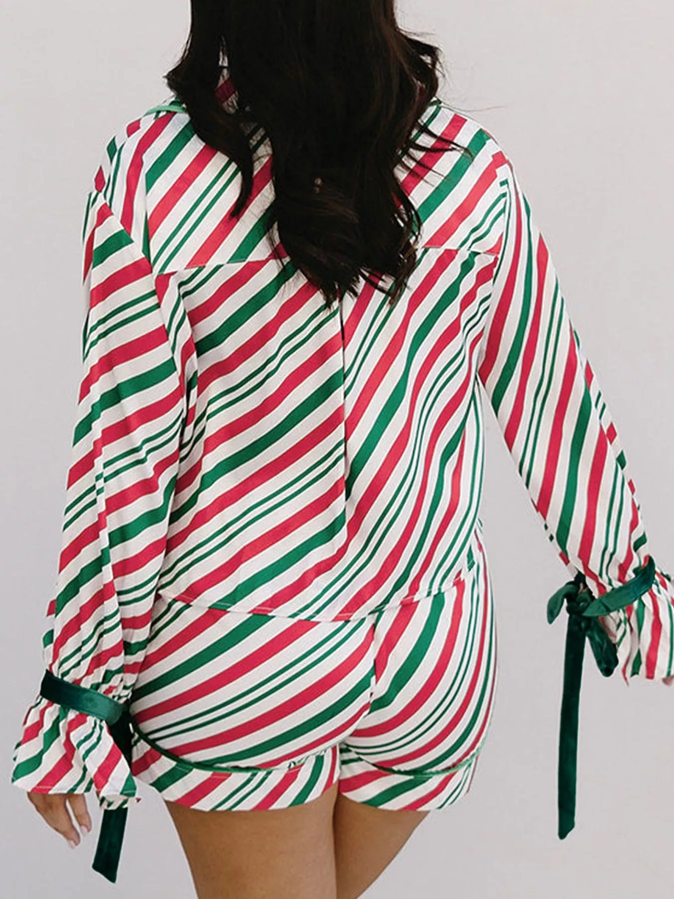Festive striped two-piece pajama set with velvet waist tie and long sleeves.