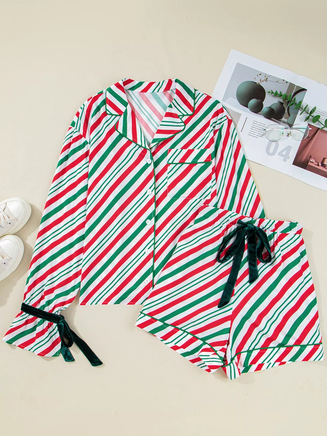 Festive striped two-piece pajama set with velvet waist tie and long sleeves.