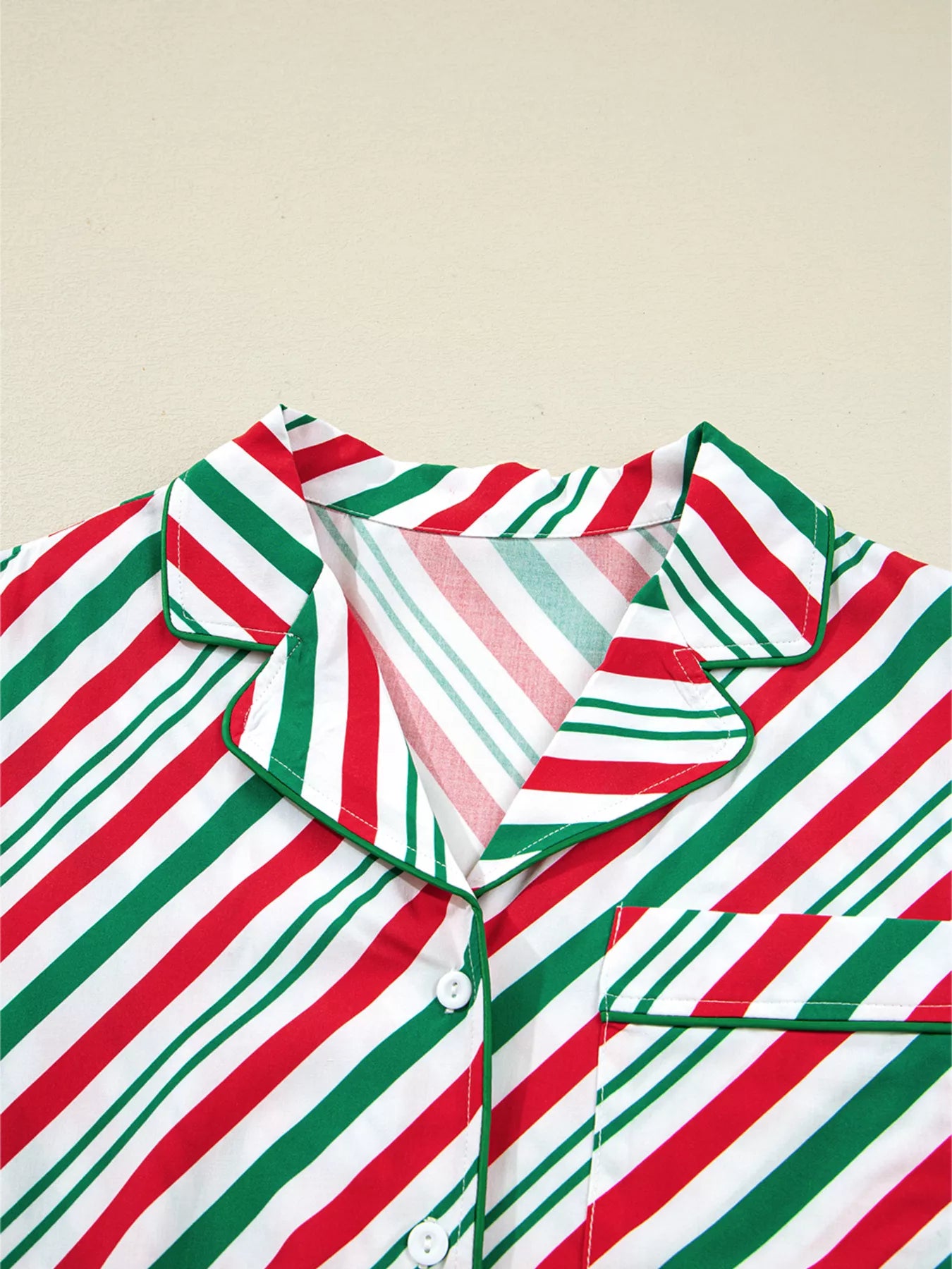 Festive striped two-piece pajama set with velvet waist tie and long sleeves.