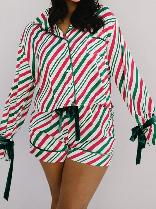 Festive striped two-piece pajama set with velvet waist tie and long sleeves.