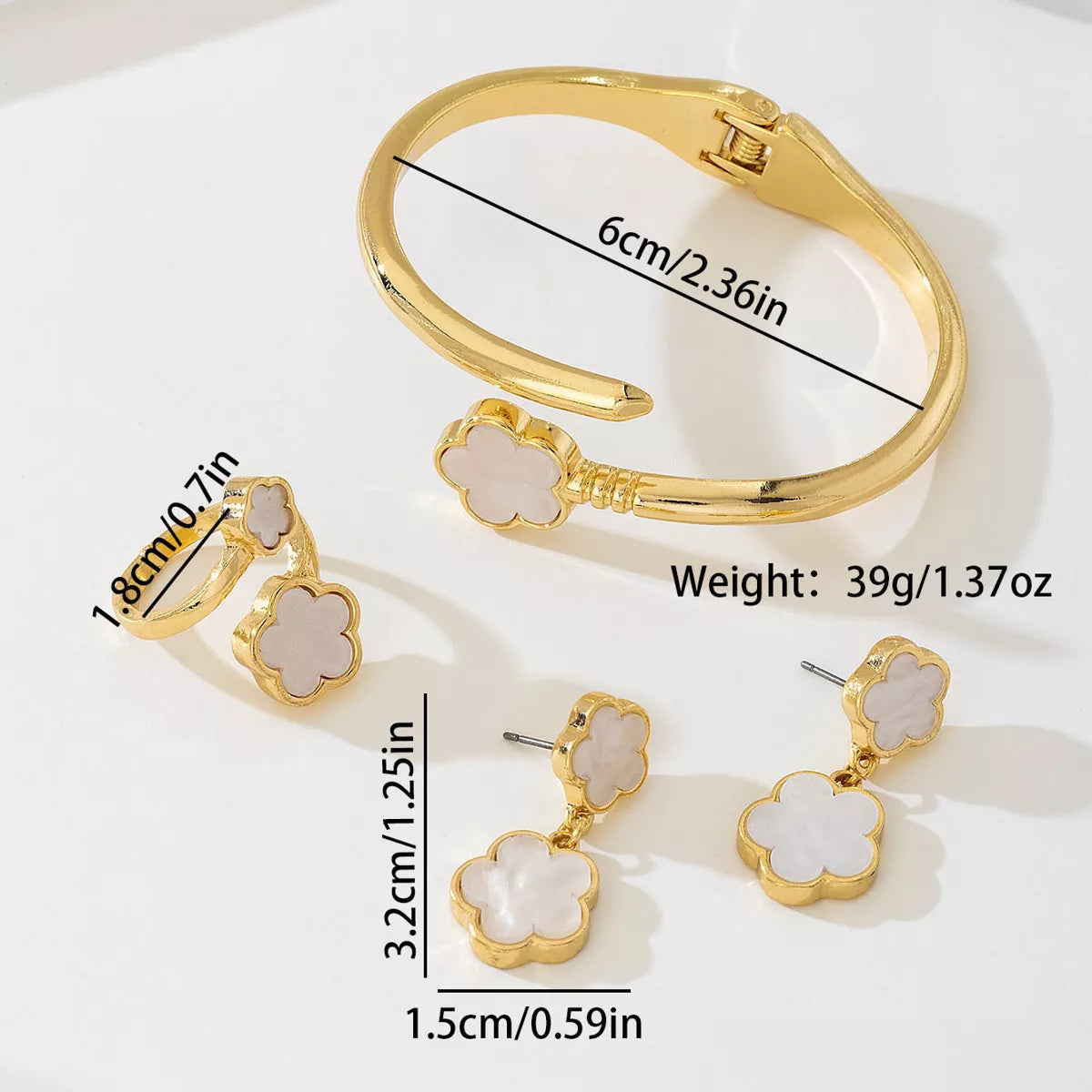 Matching gold-plated white clover jewelry set including earrings, bracelet, and ring — elegant minimalist design.