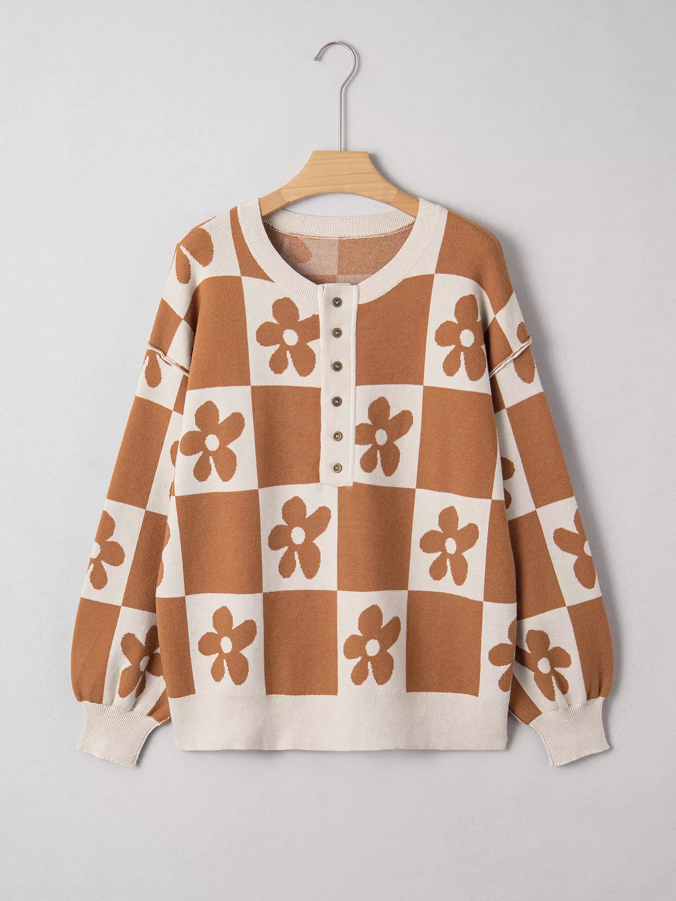 Brown and cream checkerboard henley sweater with daisy floral pattern