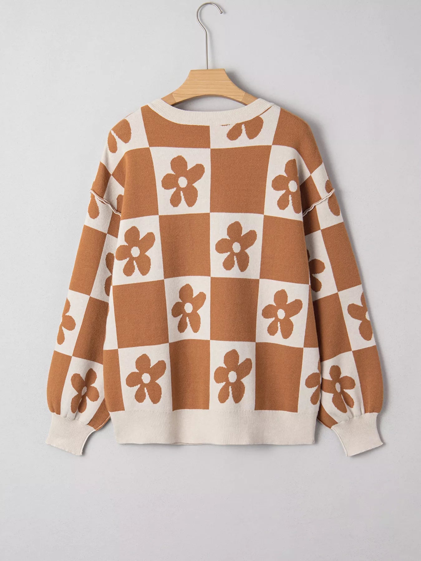 Brown and cream checkerboard henley sweater with daisy floral pattern