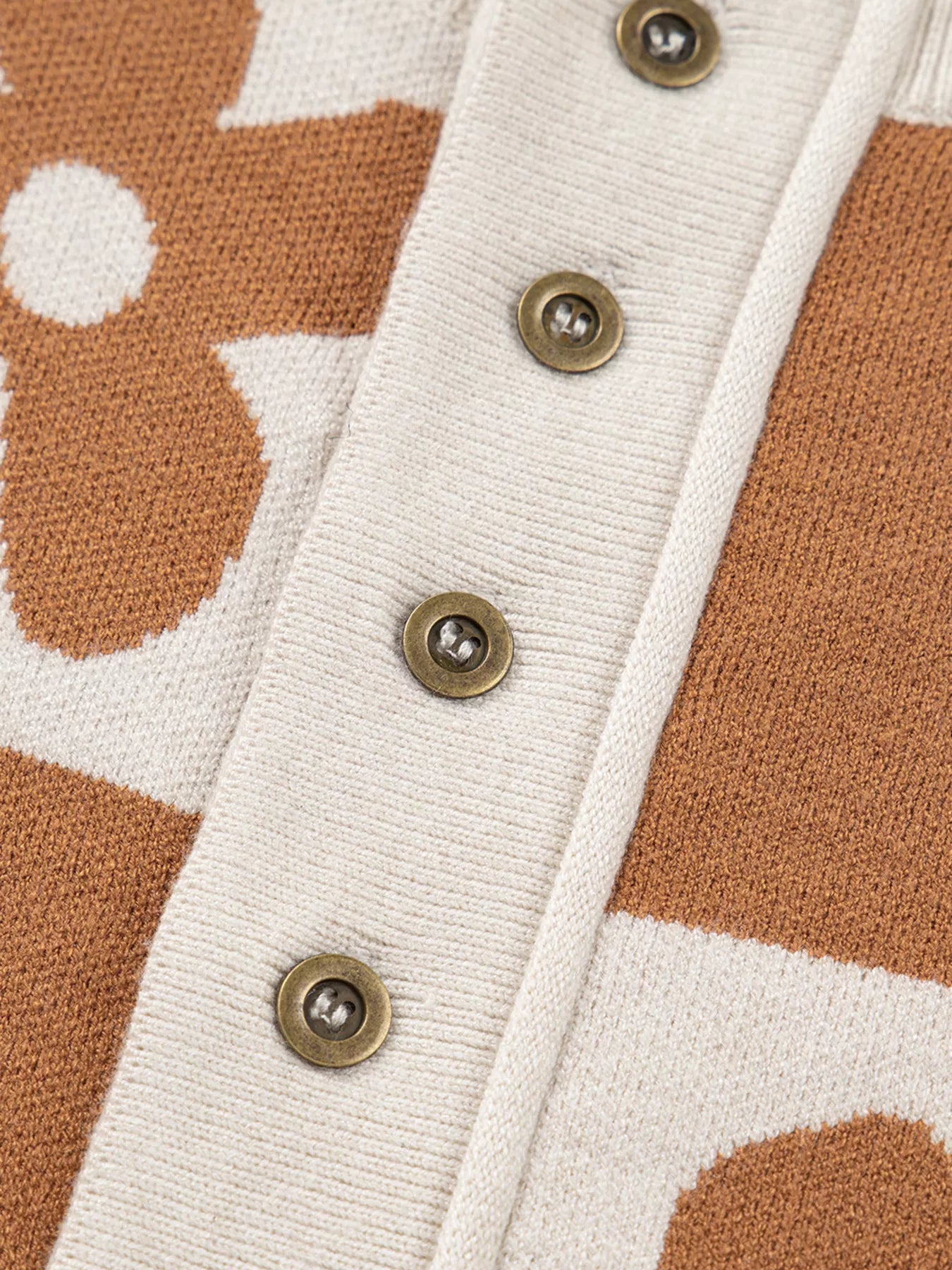 Brown and cream checkerboard henley sweater with daisy floral pattern