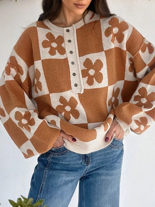 Brown and cream checkerboard henley sweater with daisy floral pattern on model with jeans