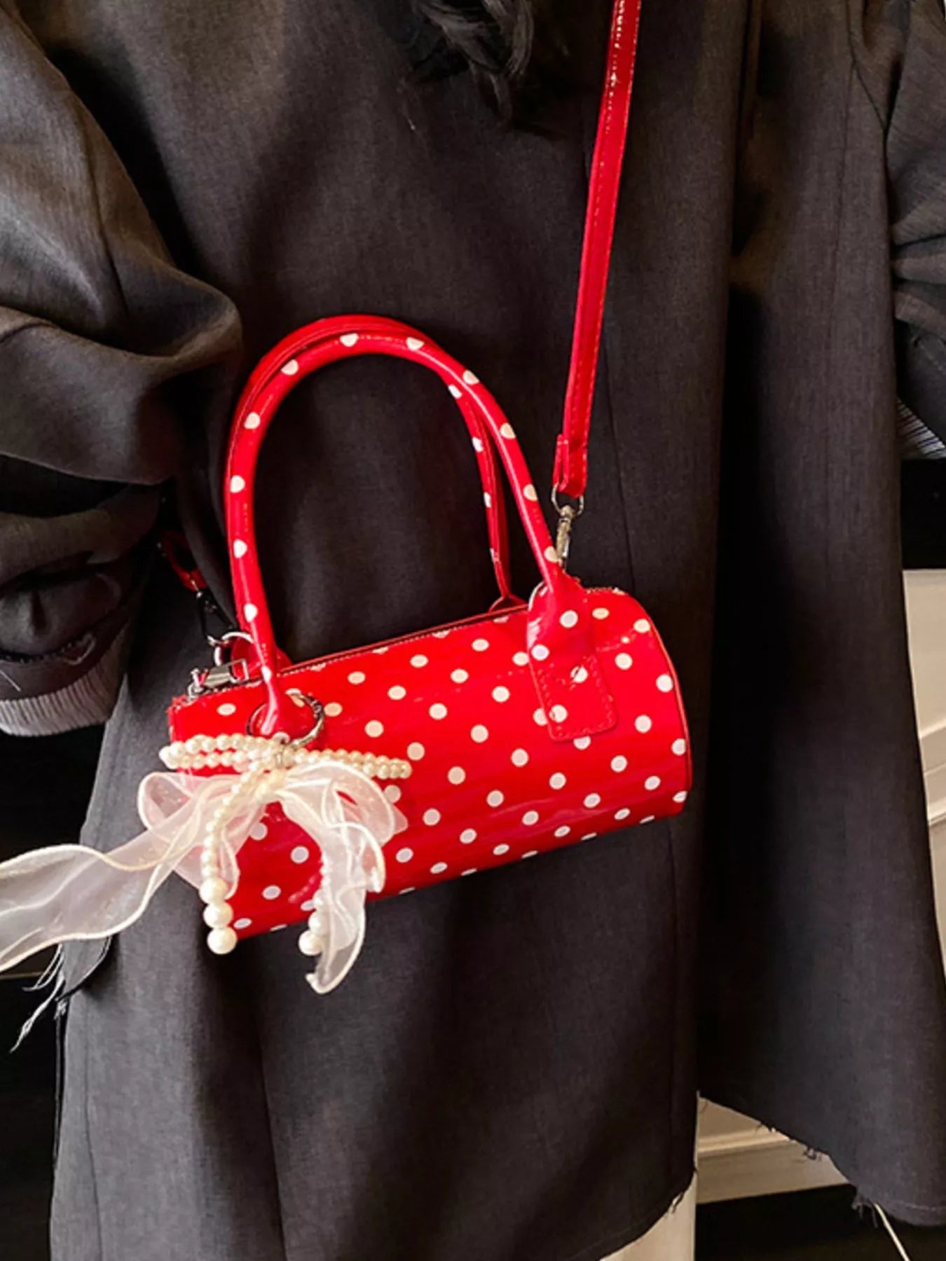 Cherry red mini purse with detachable strap and polka dot pattern.