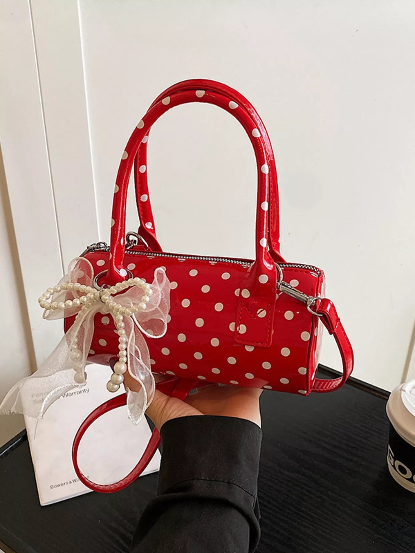 Cherry red mini purse with detachable strap and polka dot pattern.