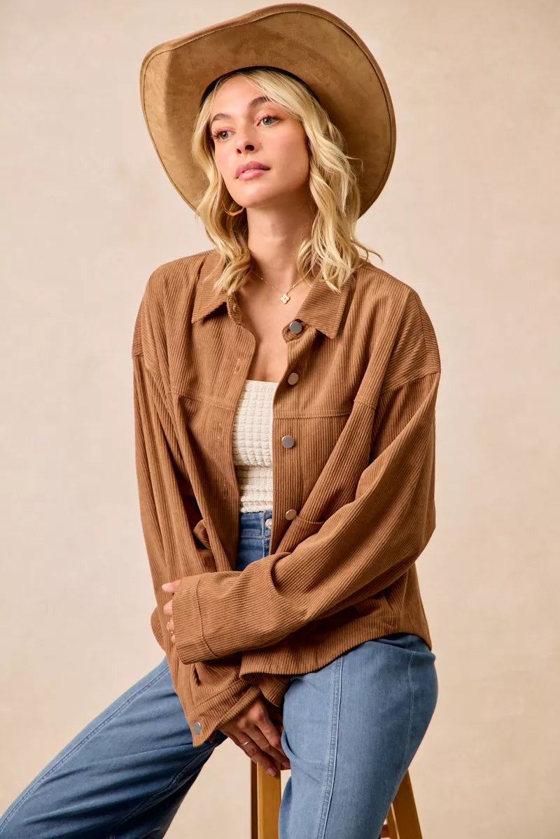 Woman wearing a brown corduroy relaxed-fit shacket with front buttons