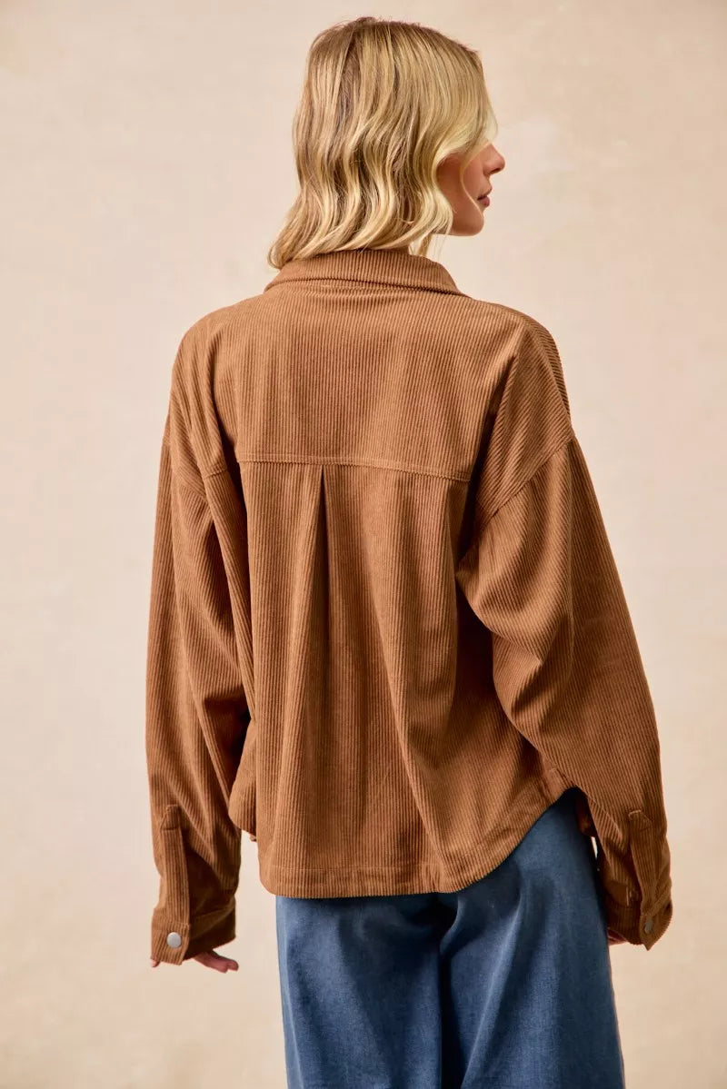 Woman wearing a brown corduroy relaxed-fit shacket with front buttons
