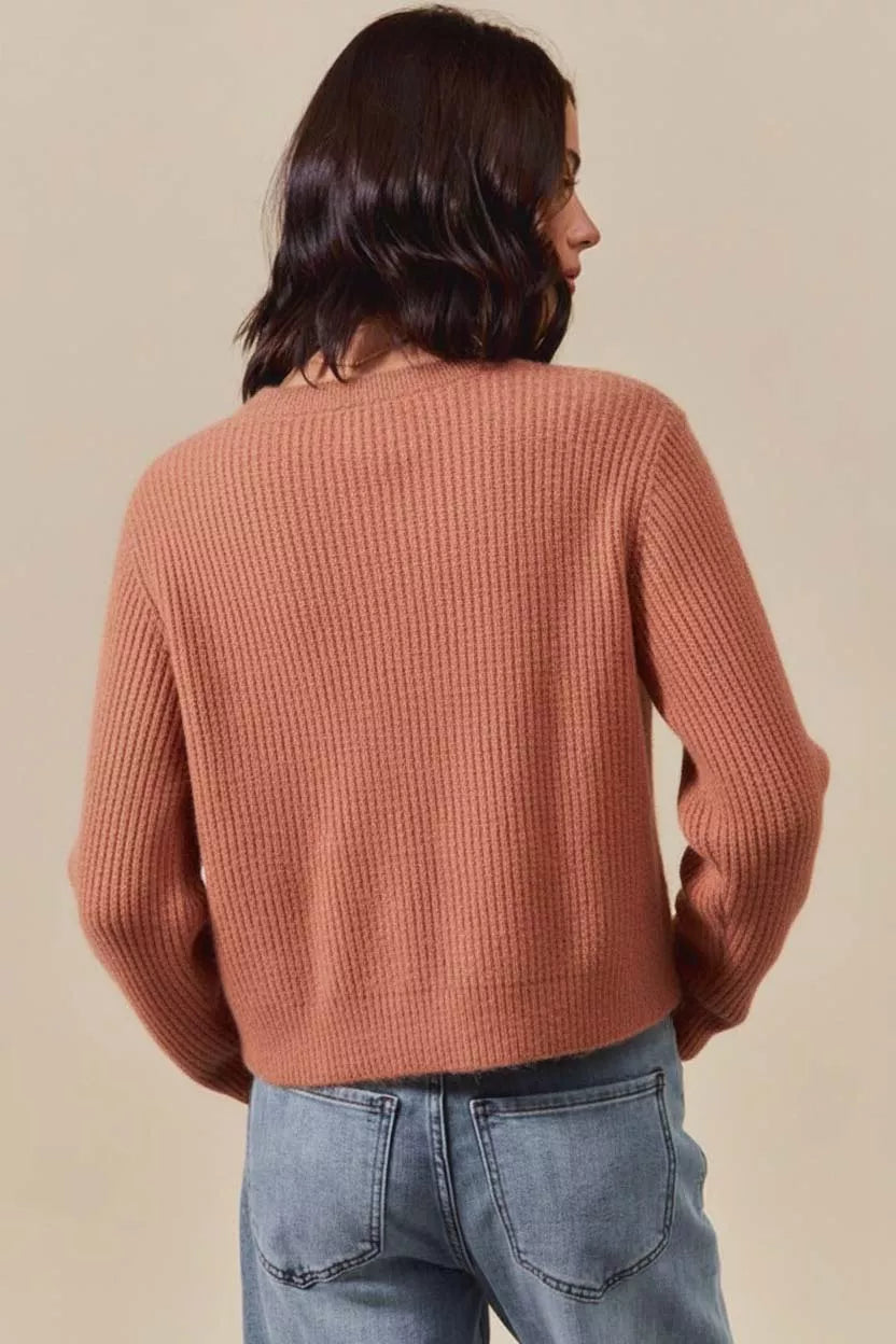 Woman wearing a rust ribbed knit sweater with plaid bows and side tie accents – cozy rustic fall fashion from A Whimsical Affair.