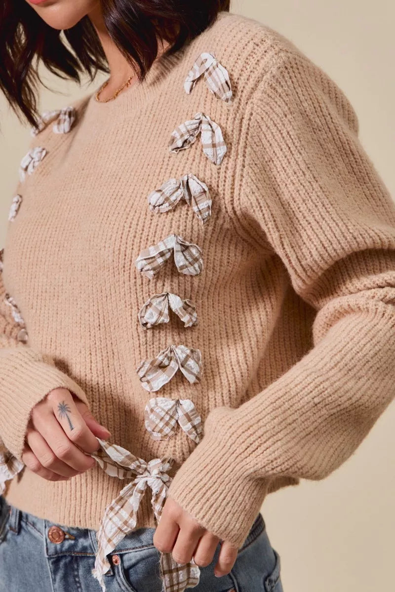 Close-up of taupe ribbed knit sweater with plaid bow accents – feminine countryside winter fashion from A Whimsical Affair.