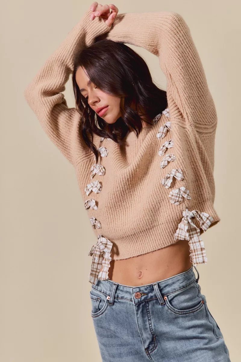 Close-up of taupe ribbed knit sweater with plaid bow accents – feminine countryside winter fashion from A Whimsical Affair.