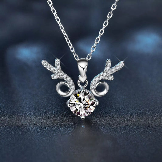 Close-up of a silver reindeer-inspired necklace with sparkling antler details and a round 1-carat moissanite center stone on a silver chain.